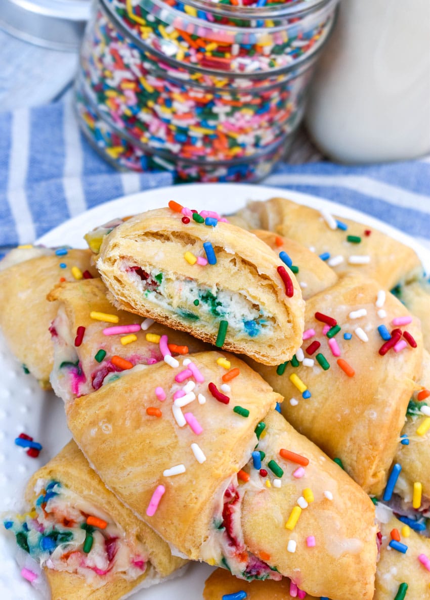 funfetti cheesecake stuffed crescent rolls piled on a small white plate