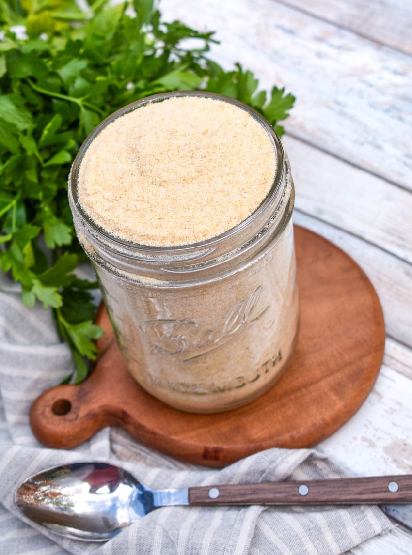 homemade bread crumbs in a glass mason jar sitting on a small wooden trivet