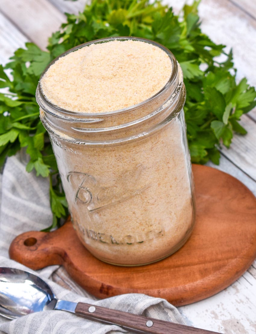 homemade bread crumbs in a glass mason jar sitting on a small wooden trivet