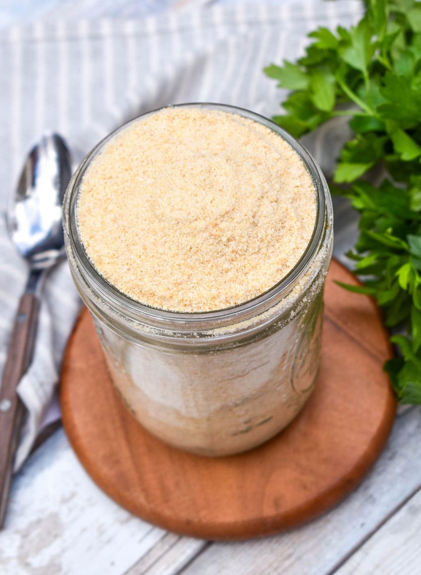 homemade bread crumbs in a glass mason jar sitting on a small wooden trivet