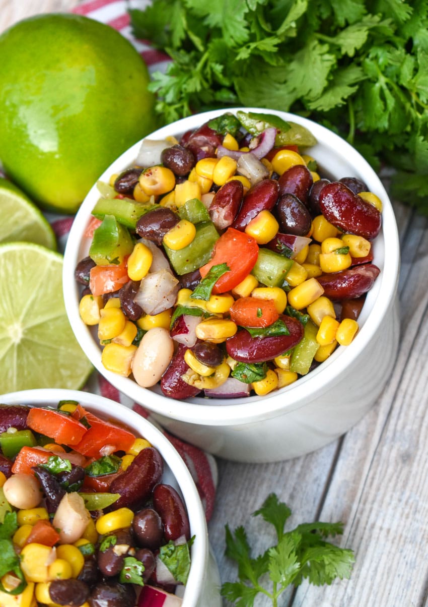 Mexican three bean salad in two small white bowls