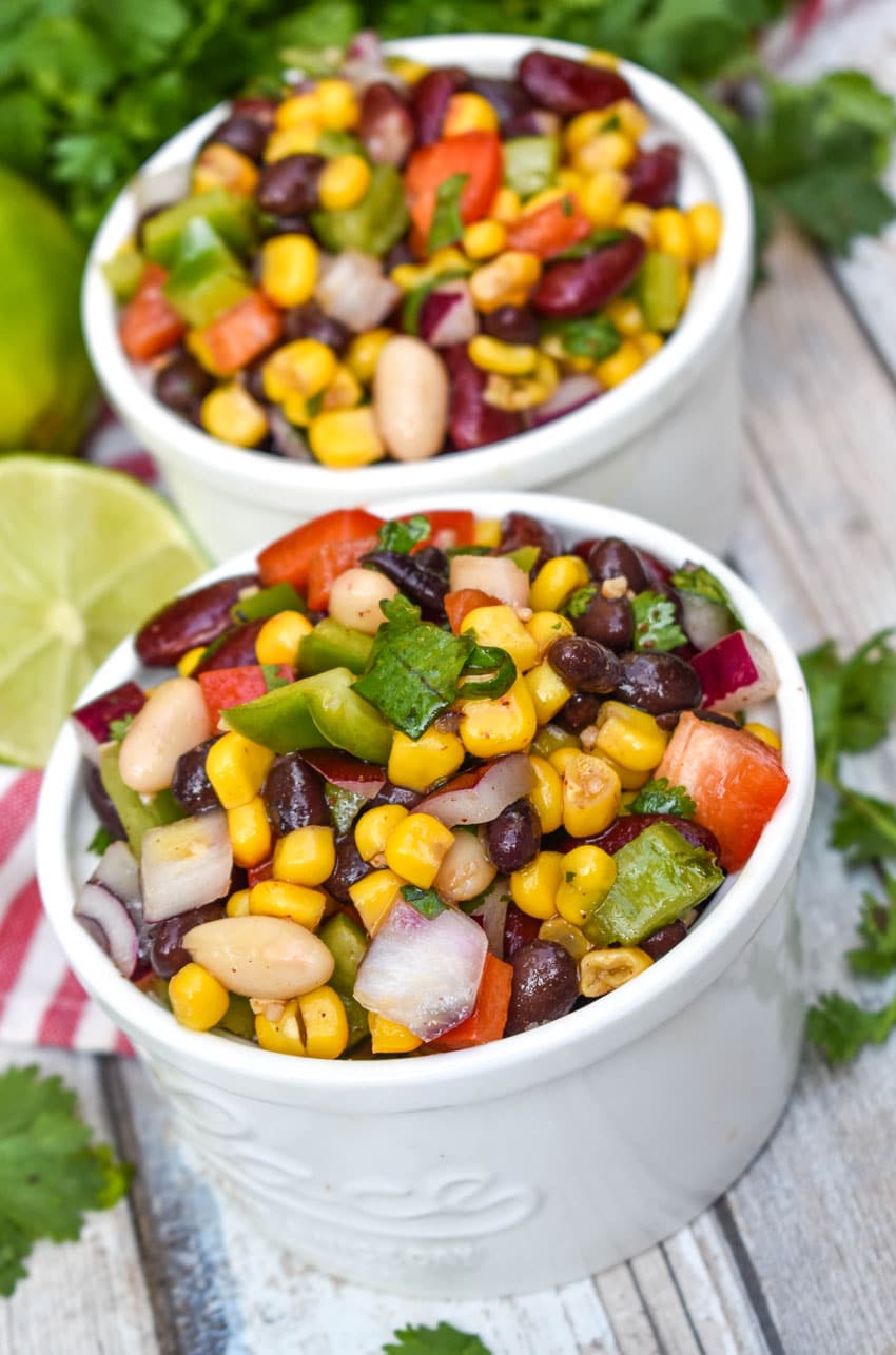 Mexican three bean salad in two small white bowls