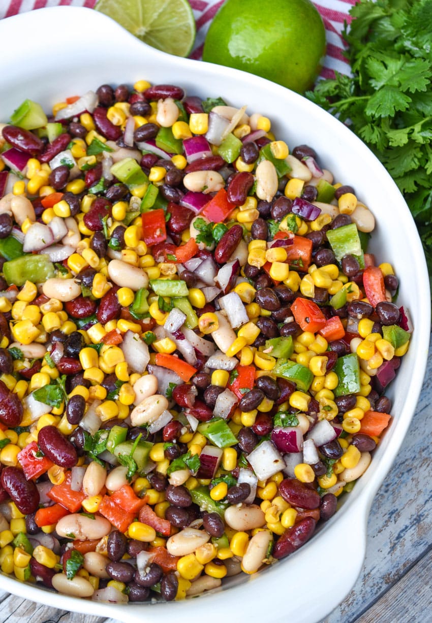 mexican three bean salad in a white serving bowl