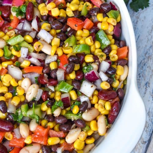 mexican three bean salad in a white serving bowl