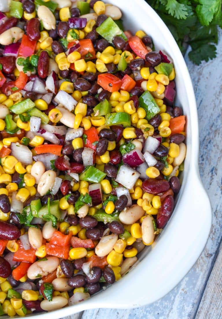 mexican three bean salad in a white serving bowl