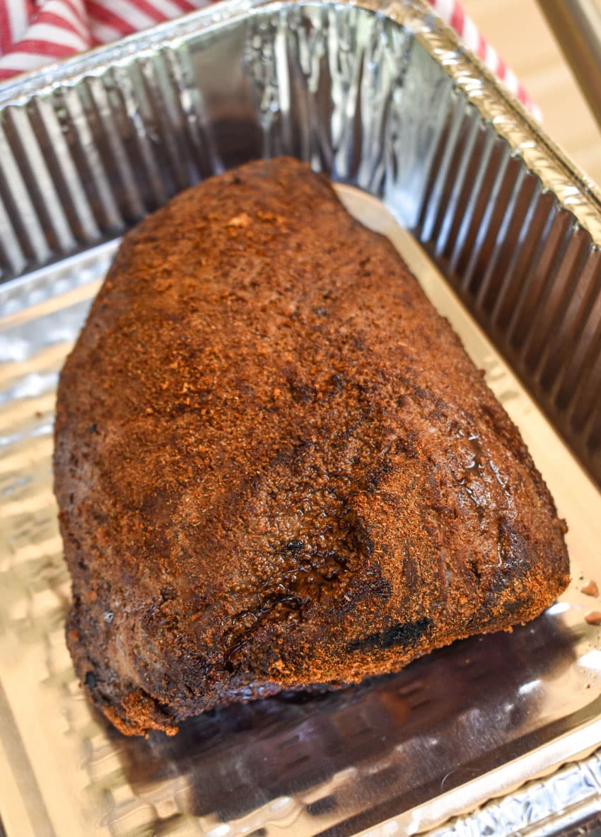 a smoked chuck roast resting in an aluminum pan