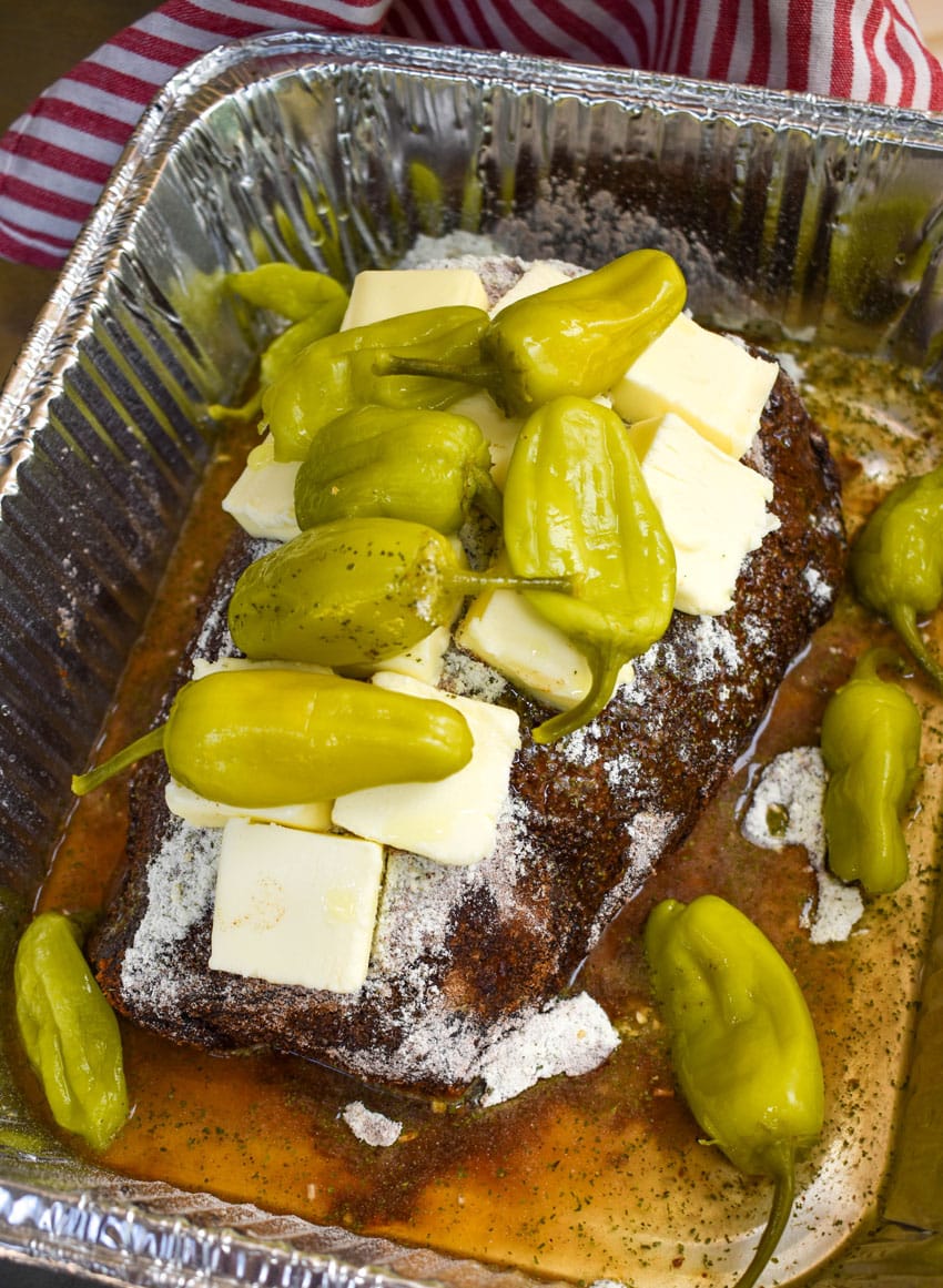 a smoked mississippi pot roast in an aluminum pan