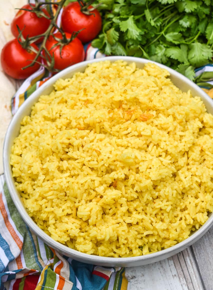 yellow basmati rice in a shallow white serving bowl