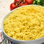 yellow basmati rice in a shallow white serving bowl