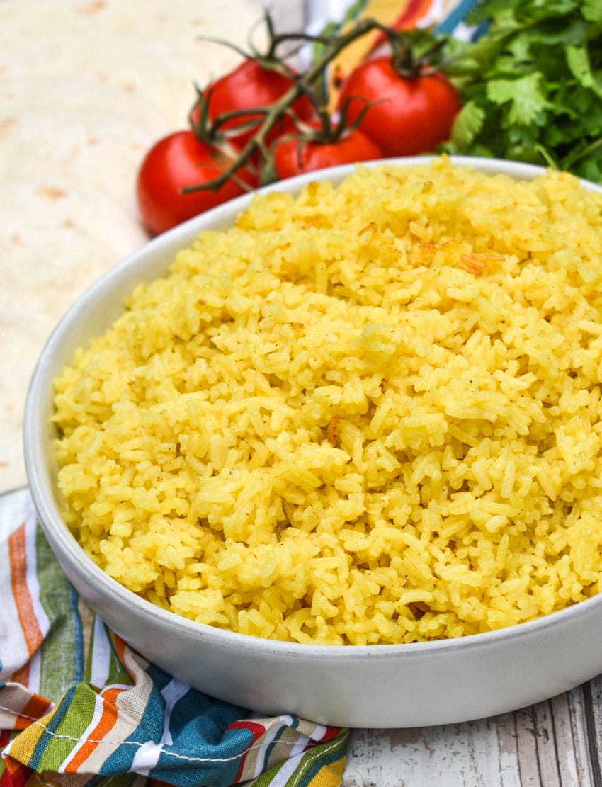 yellow basmati rice in a shallow white serving bowl