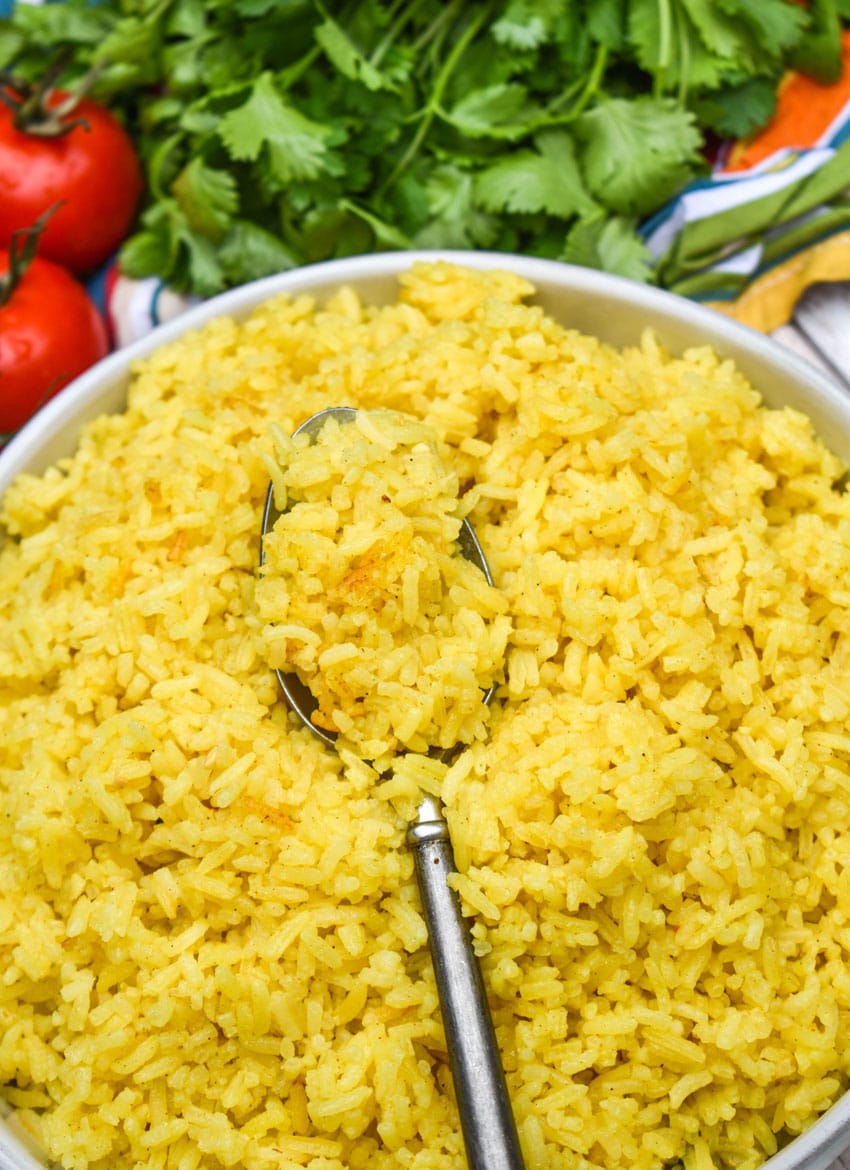 yellow basmati rice in a shallow white serving bowl