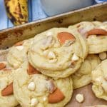banana pudding cookies on a parchment paper lined baking sheet