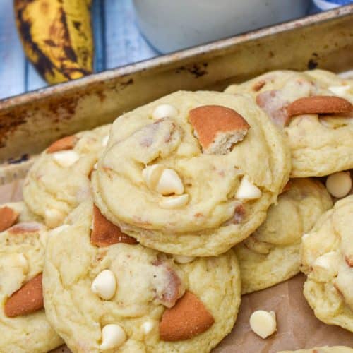 banana pudding cookies on a parchment paper lined baking sheet