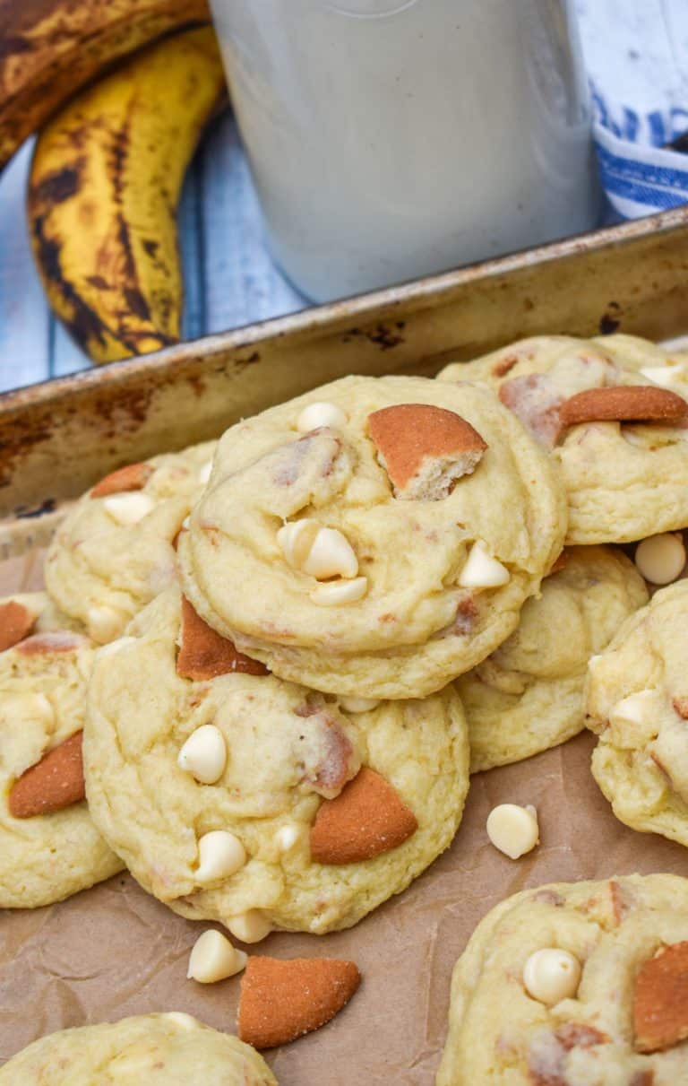 banana pudding cookies on a parchment paper lined baking sheet