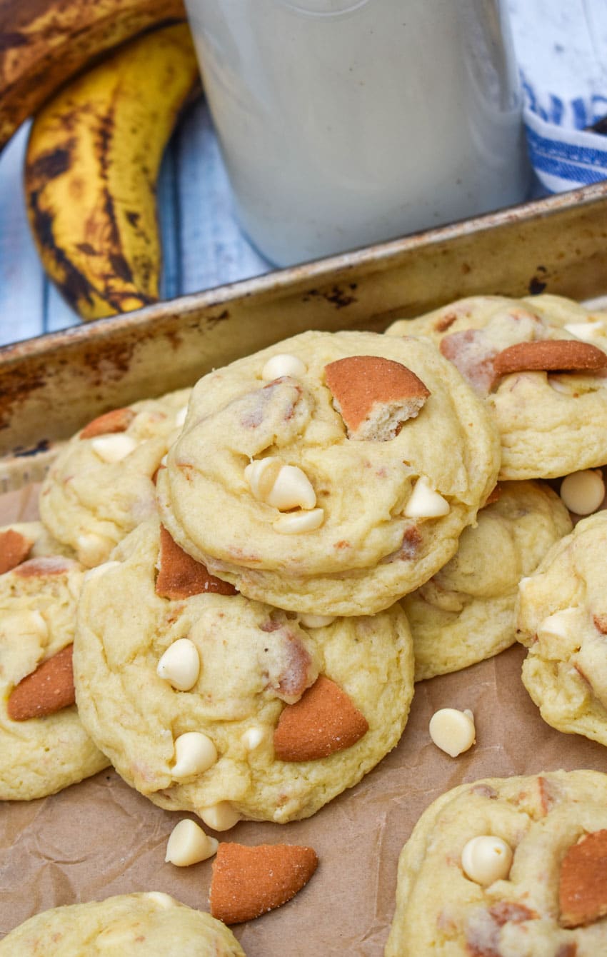 banana pudding cookies on a parchment paper lined baking sheet