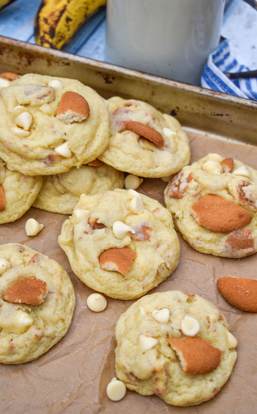 banana pudding cookies on a parchment paper lined baking sheet