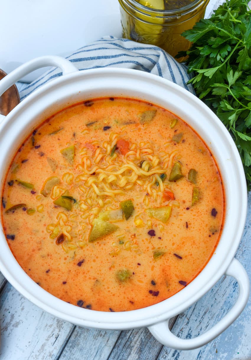 cheesy dill pickle ramen in a large white soup pot