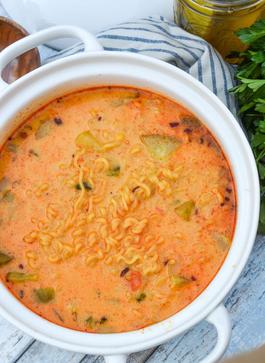 cheesy dill pickle ramen in a large white soup pot