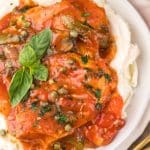 slow cooker chicken cacciatore over mashed potatoes on a white plate