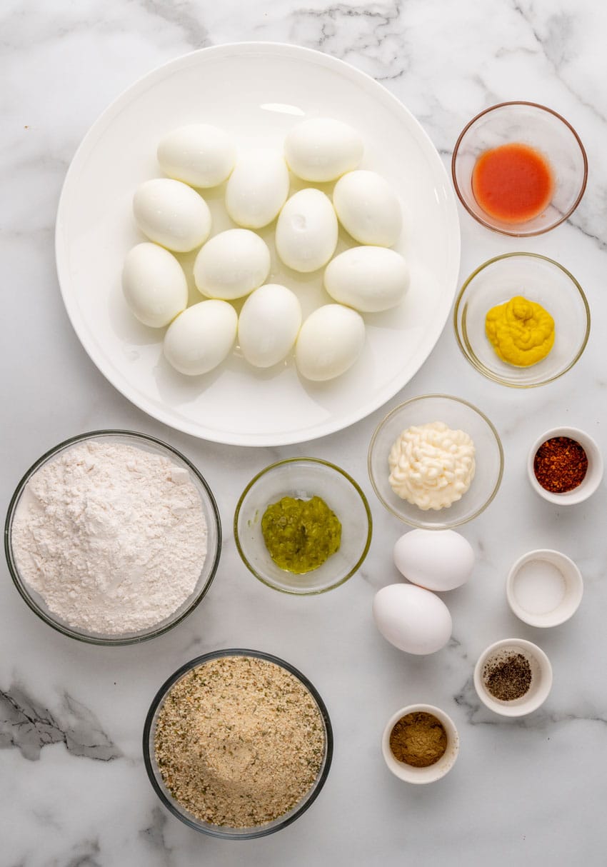 an overhead image showing the measured ingredients needed to make a batch of deep fried deviled eggs