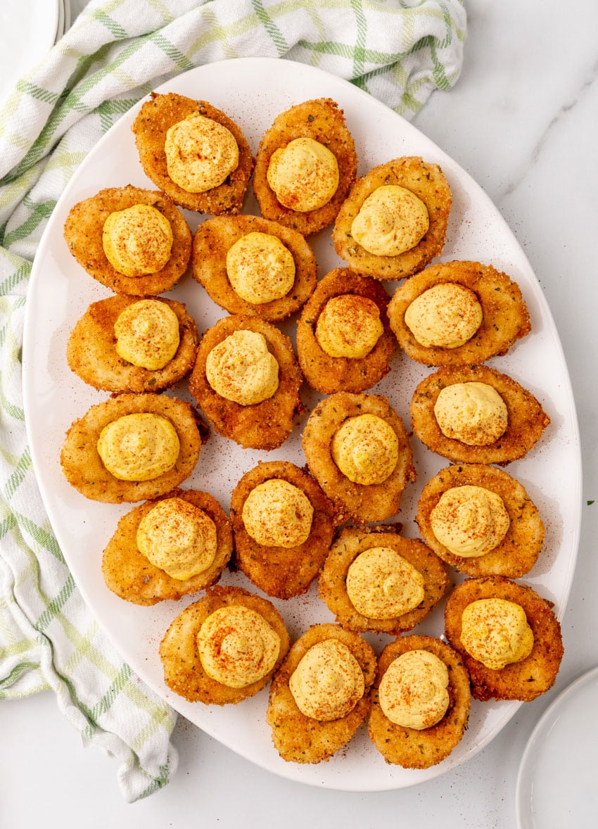 cajun style fried deviled eggs on a white serving platter