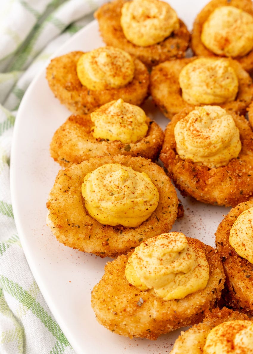 cajun style fried deviled eggs on a white serving platter