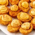 cajun style fried deviled eggs on a white serving platter