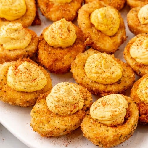 cajun style fried deviled eggs on a white serving platter