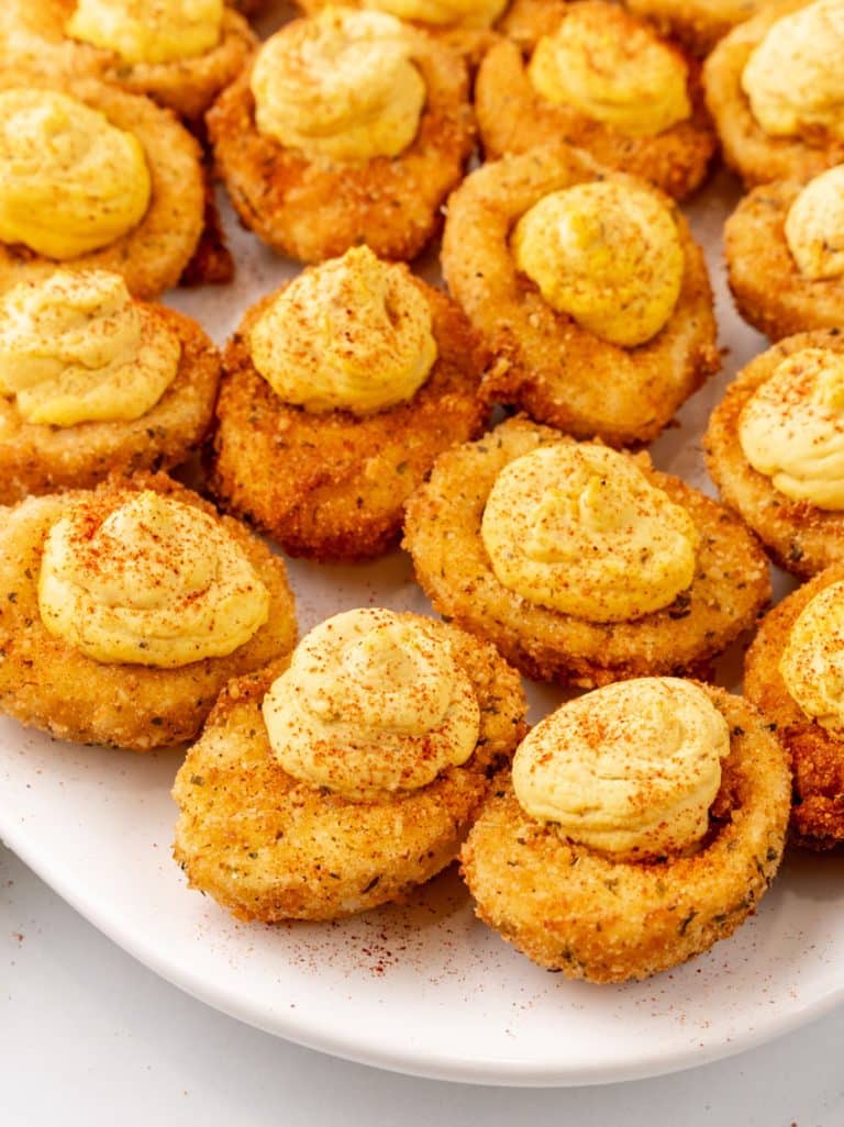 cajun style fried deviled eggs on a white serving platter