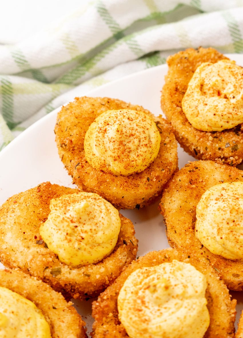 cajun style fried deviled eggs on a white serving platter