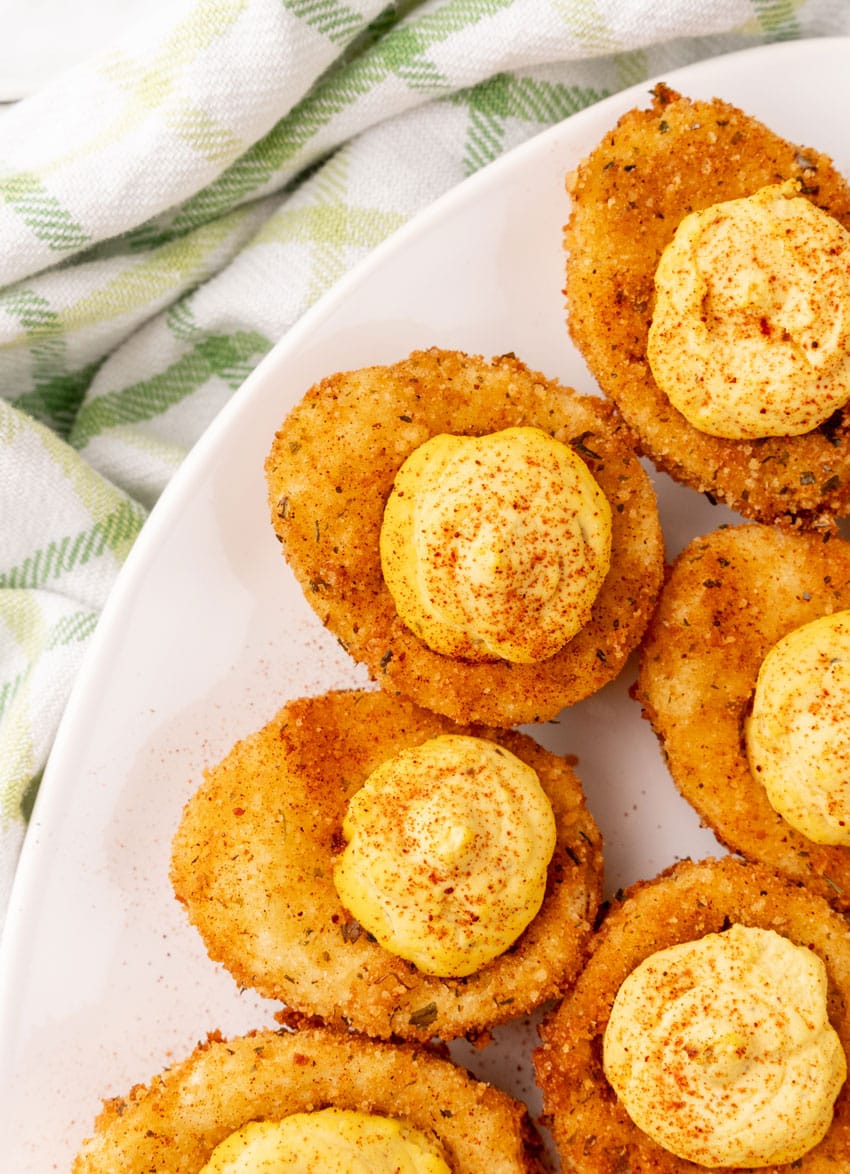 cajun style fried deviled eggs on a white serving platter