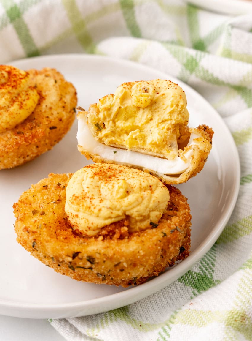 cajun fried deviled eggs on a small white appetizer plate