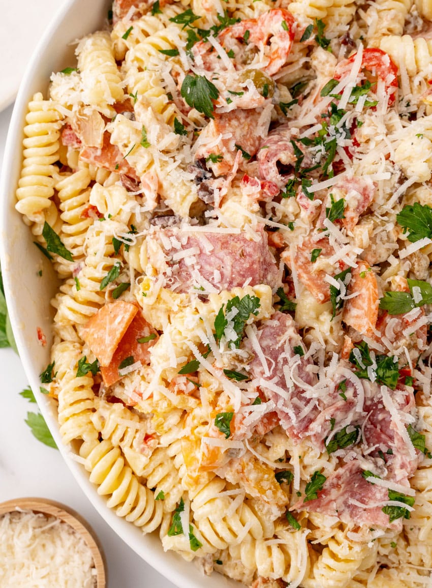 muffuletta pasta salad in a large white serving bowl