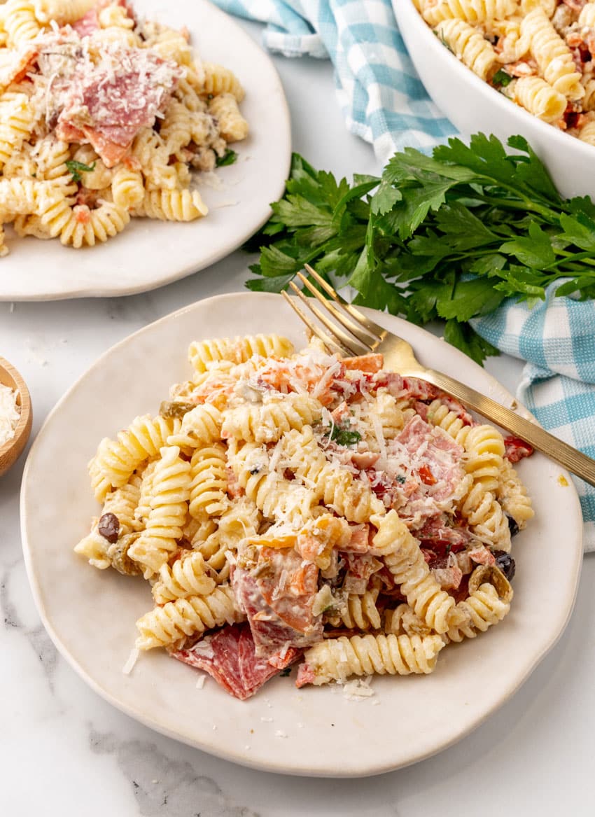 muffuletta pasta salad on two small white plates