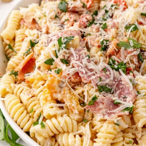 muffuletta pasta salad in a large white serving bowl