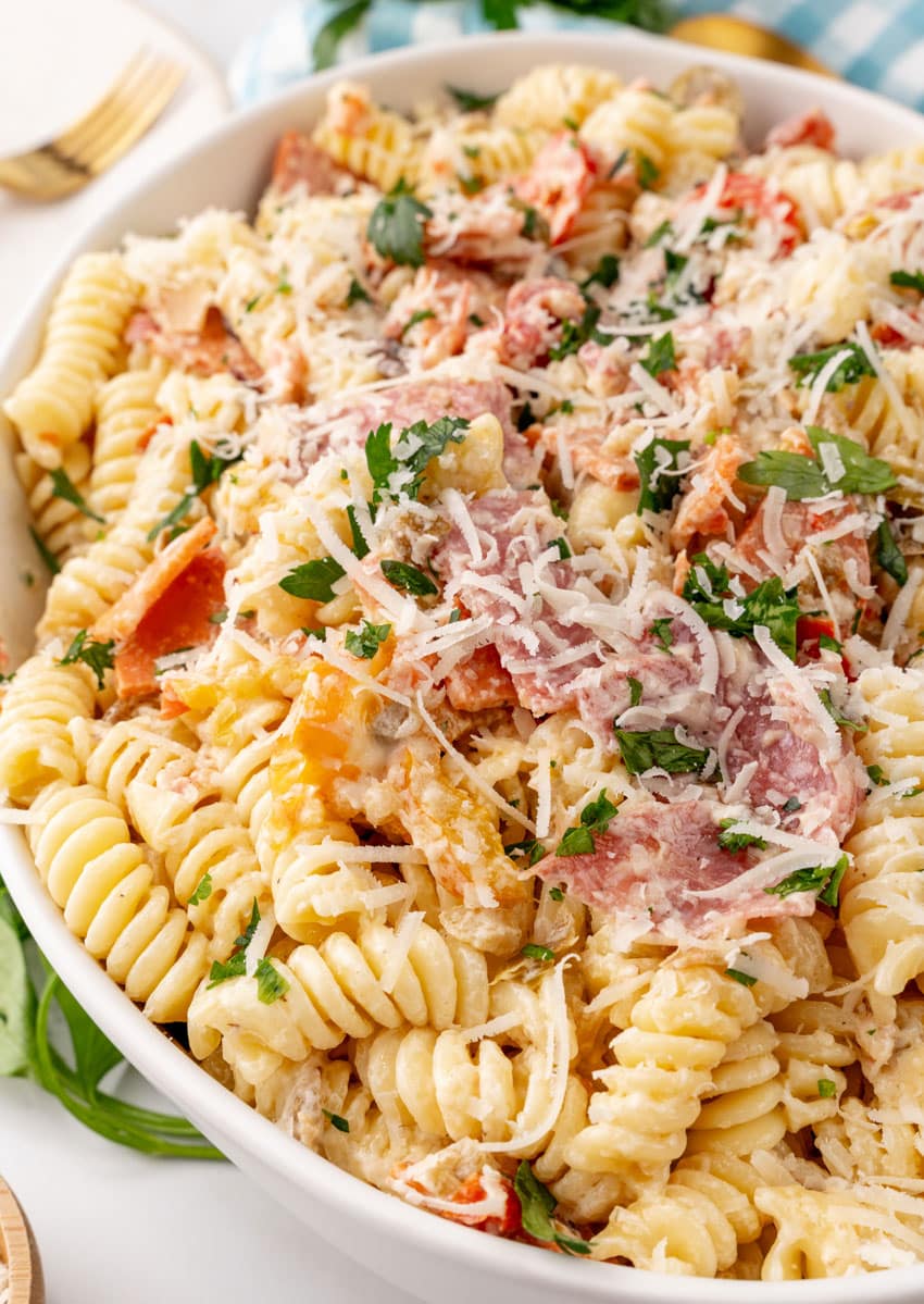 muffuletta pasta salad in a large white serving bowl
