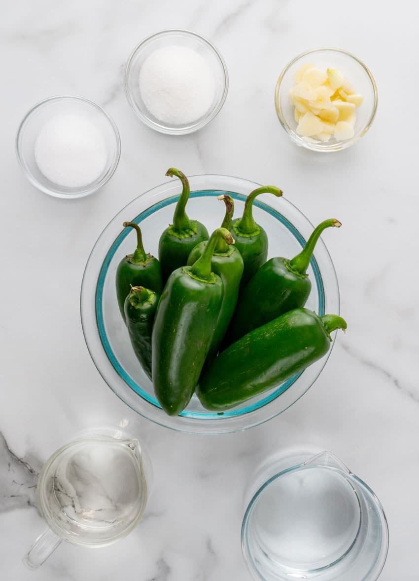 an overhead image showing the measured ingredients needed to make a batch of homemade pickled jalapenos