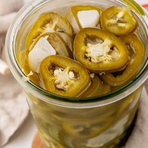 easy pickled jalapenos in a small glass jar