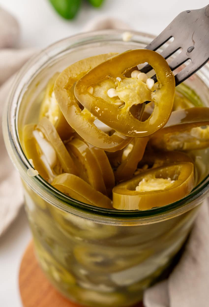 easy pickled jalapenos in a small glass jar