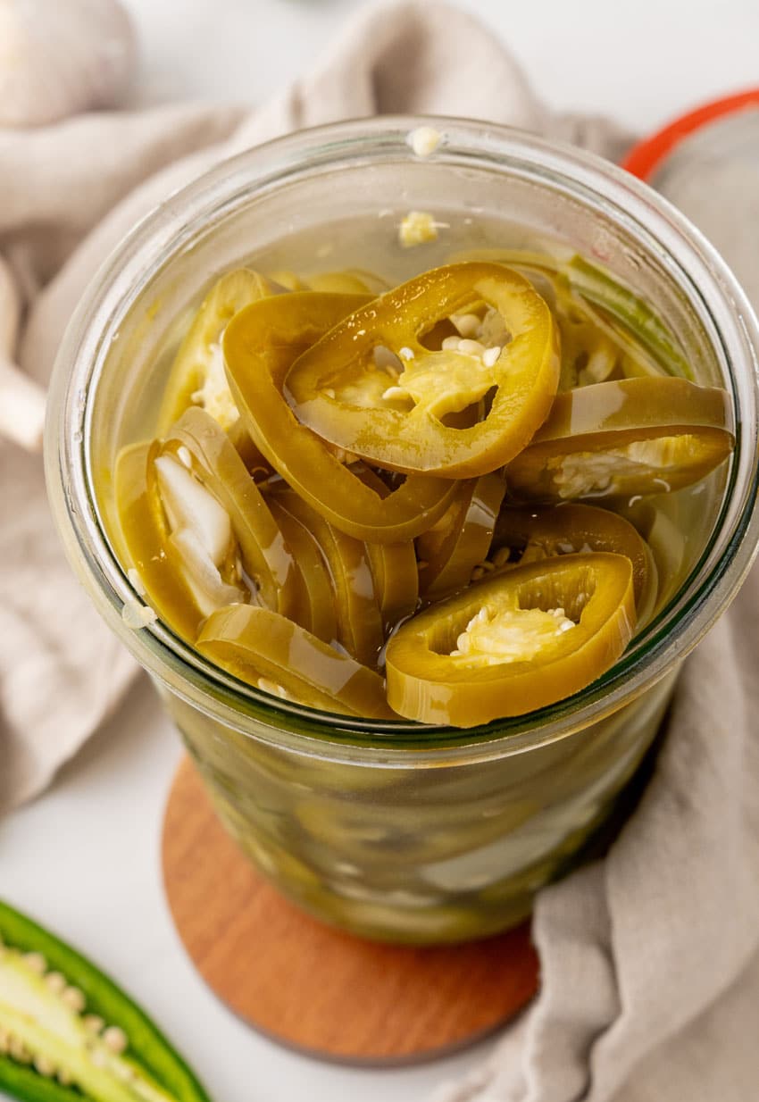 easy pickled jalapenos in a small glass jar