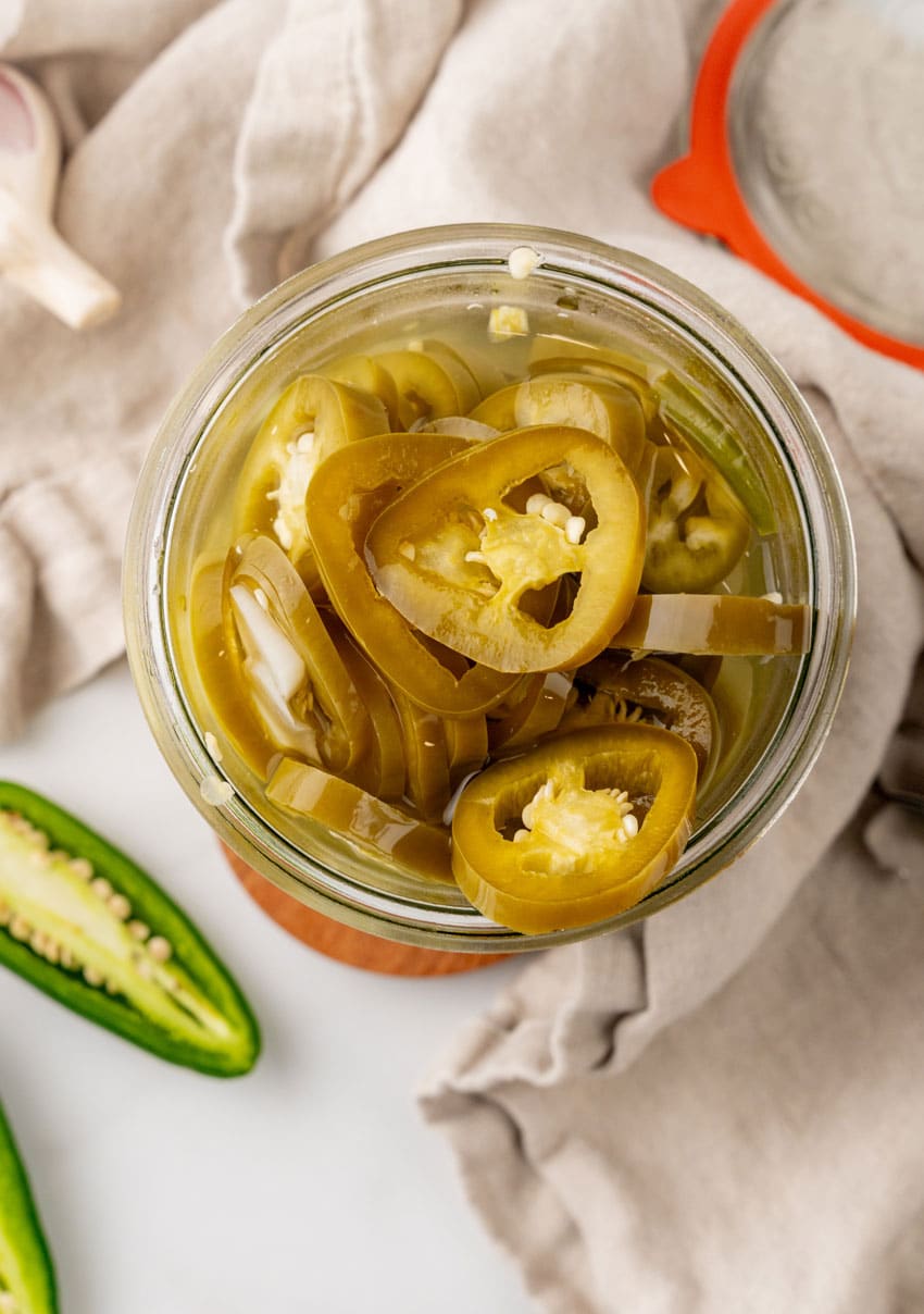 easy pickled jalapenos in a small glass jar