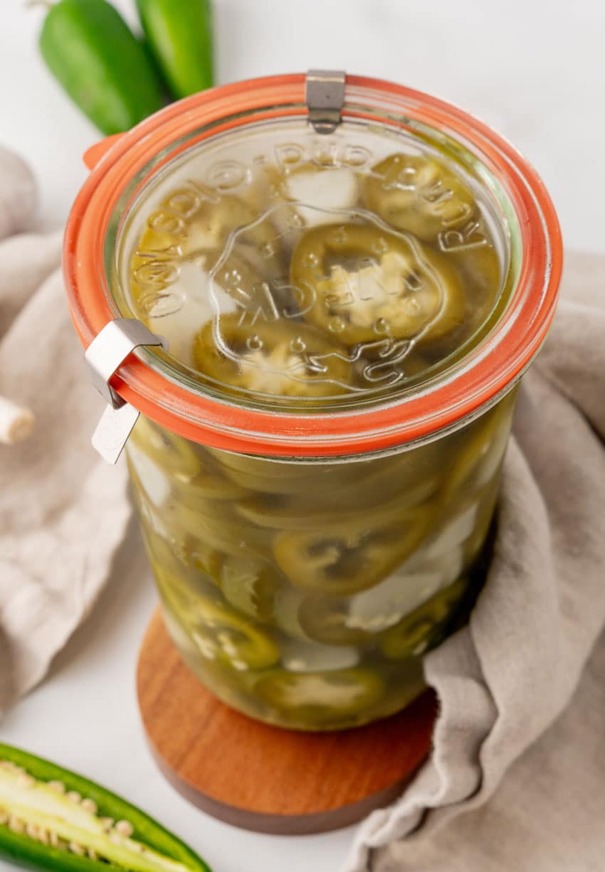 homemade pickled jalapenos in a small glass jar