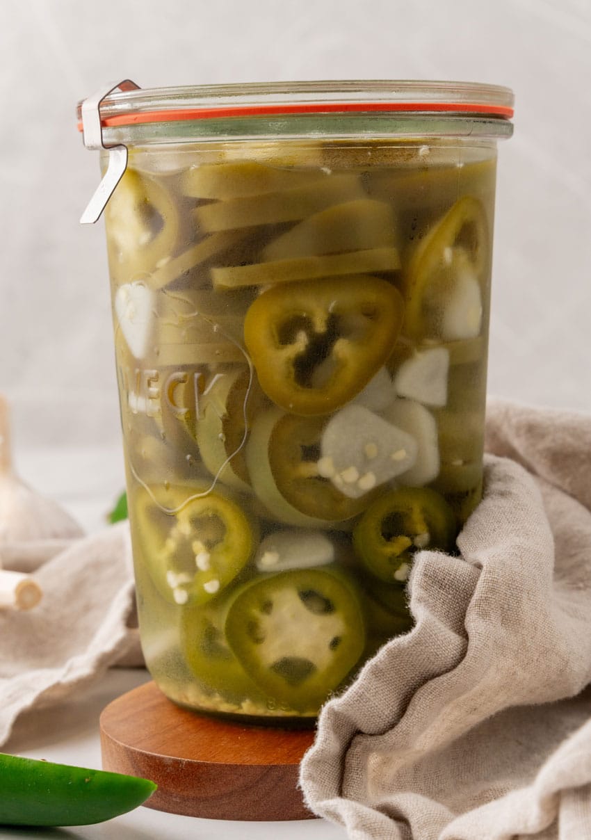 homemade pickled jalapenos in a small glass jar
