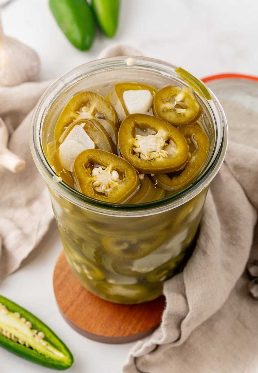 easy pickled jalapenos in a small glass jar