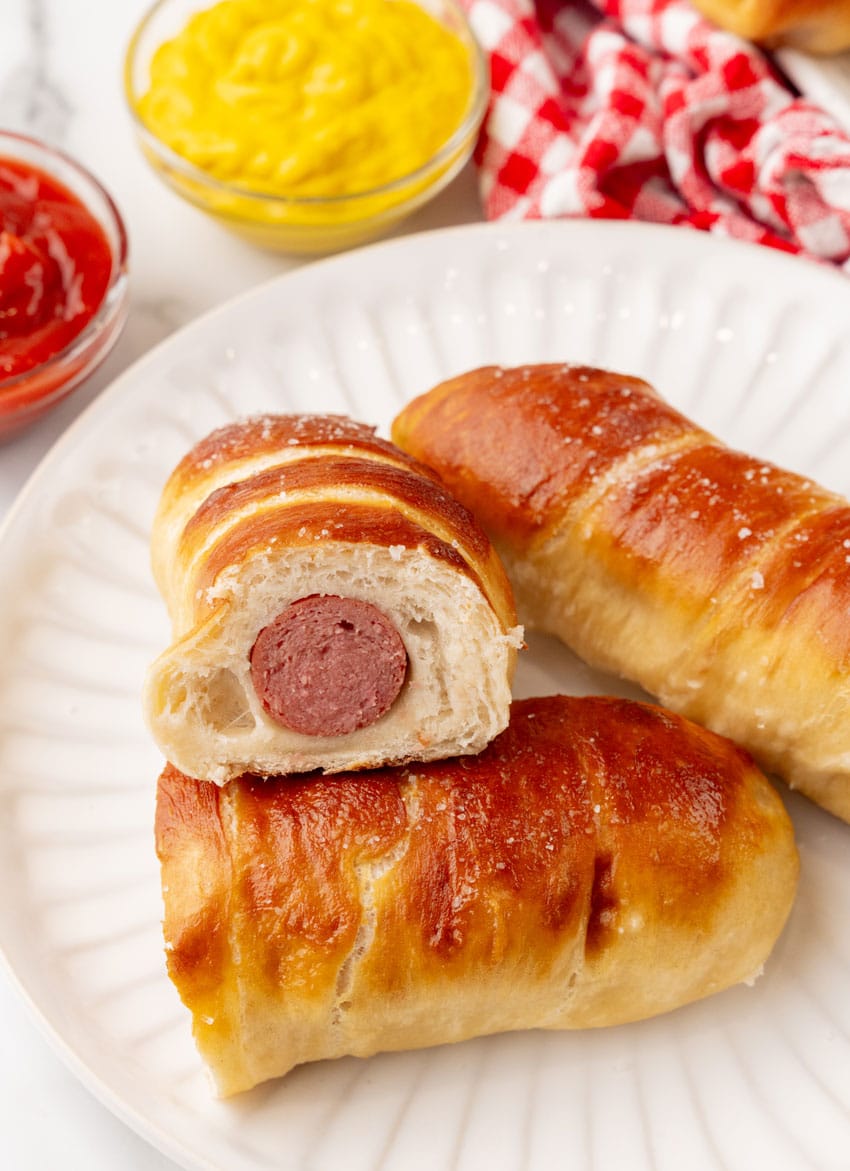 homemade pretzel dogs on a white plate