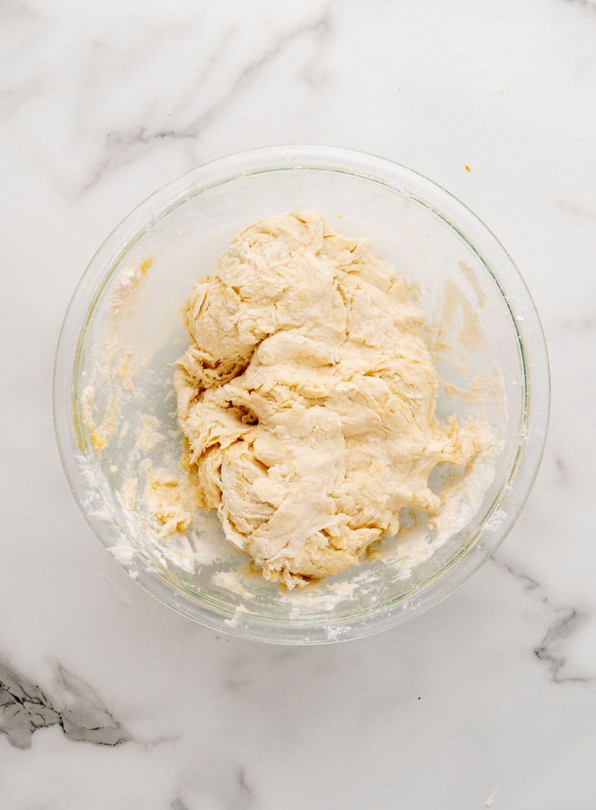 homemade pretzel dough in a glass mixing bowl