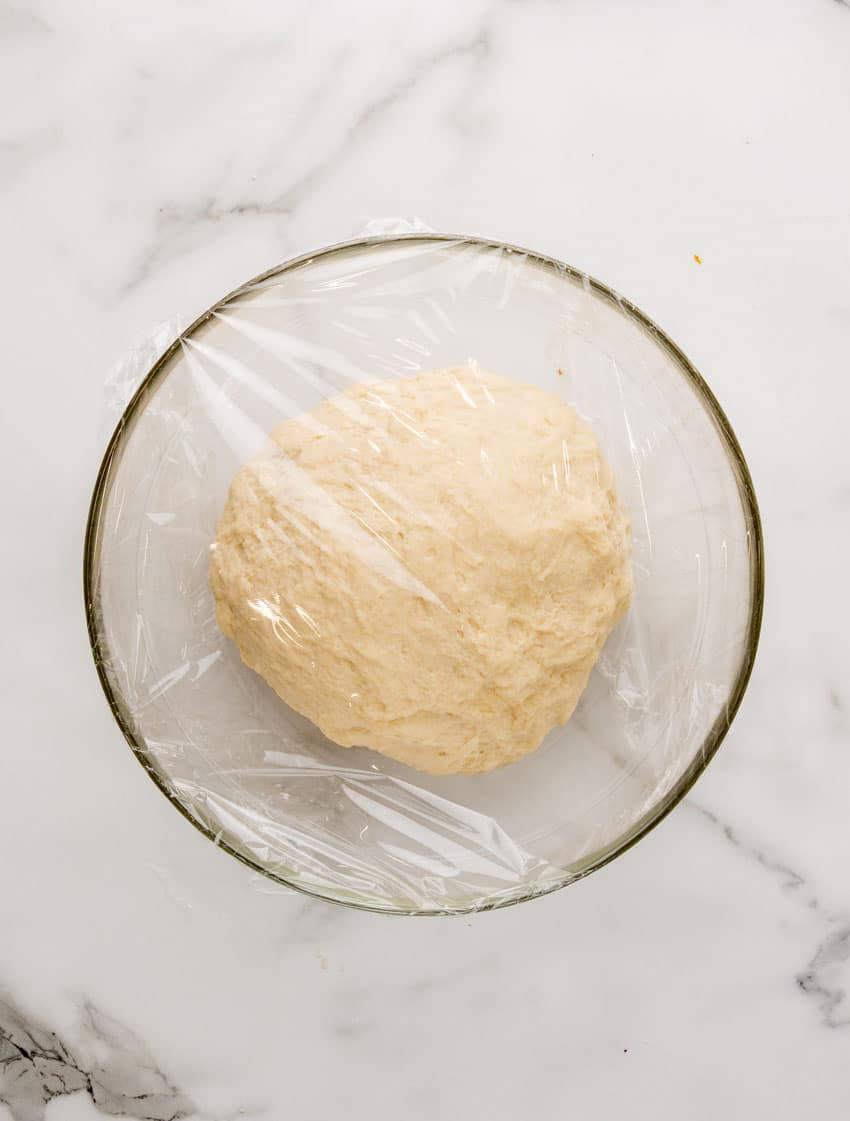 homemade pretzel dough in a glass mixing bowl
