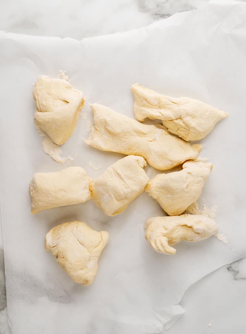 8 balls of homemade pretzel dough on a piece of white parchment paper