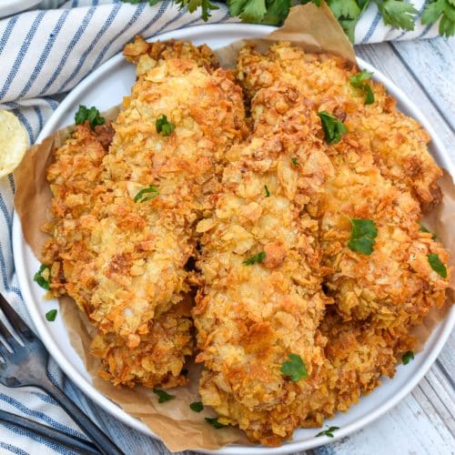 air fryer potato chip chicken tenders stacked on a white plate