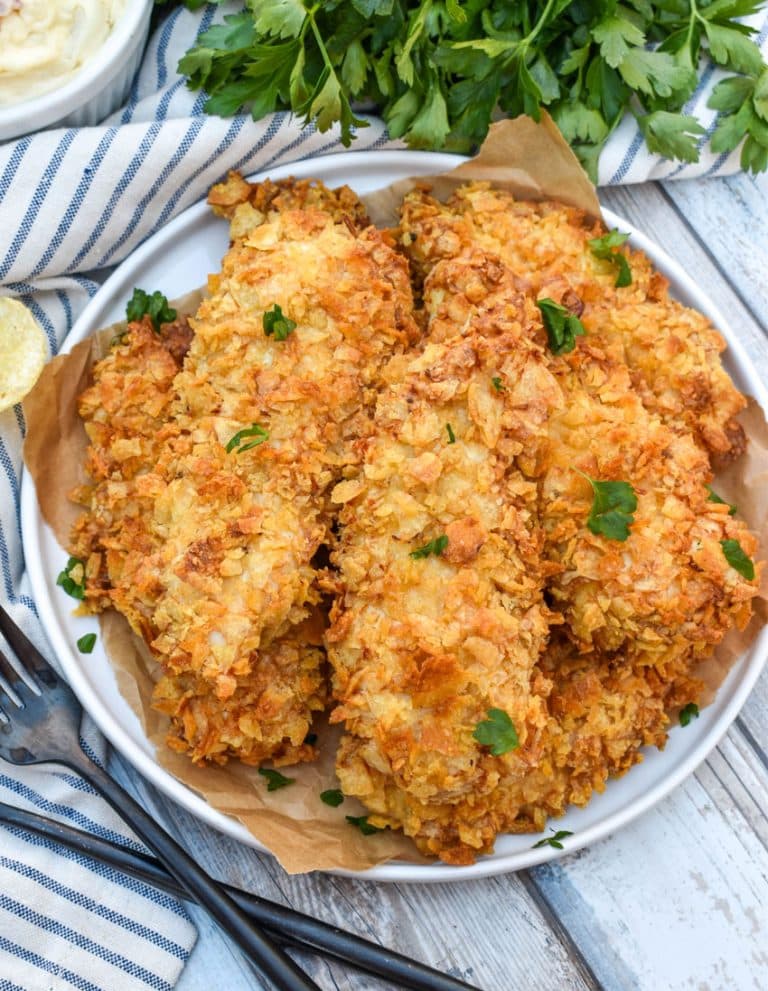 air fryer potato chip chicken tenders stacked on a white plate